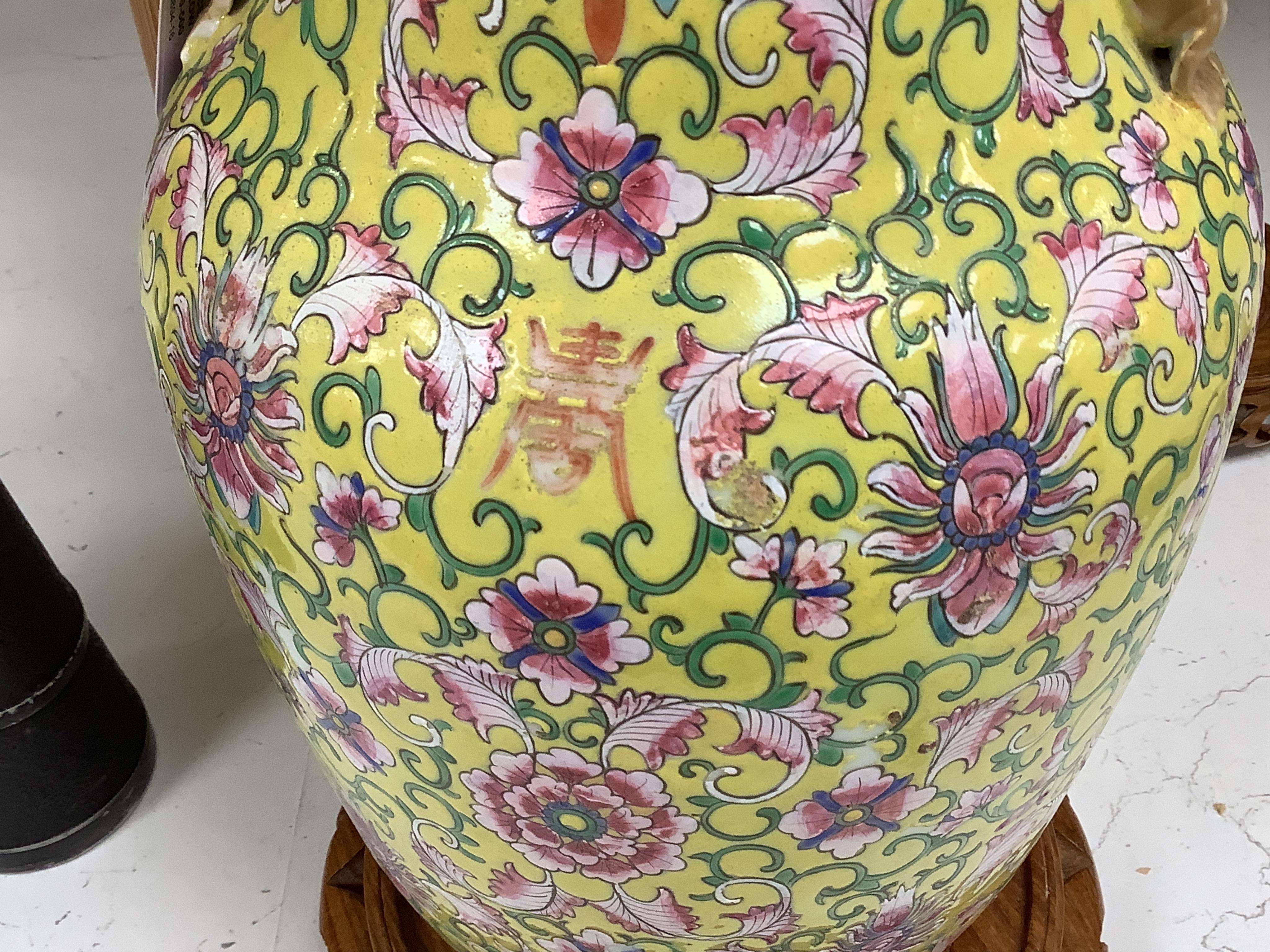 A late 19th century Chinese yellow ground porcelain vase, with gilt chilong handle, decorated with flowers and tendrils, iron red bands to the scalloped neck (including two stands), 35cm high. Condition - chip to top edg